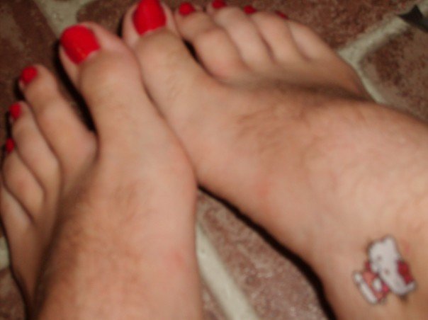 Hello Kitty tattoos on the hairy feet of men with painted toe nails take