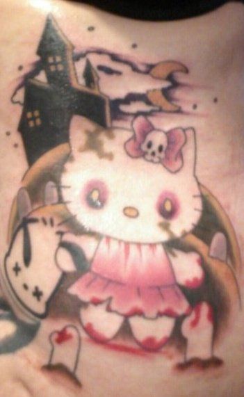 Colored Hello Kitty With Gun Tattoo On Left Shoulder